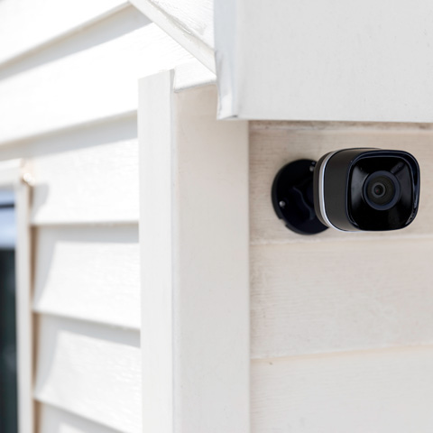 surveillance camera mounted on side of house